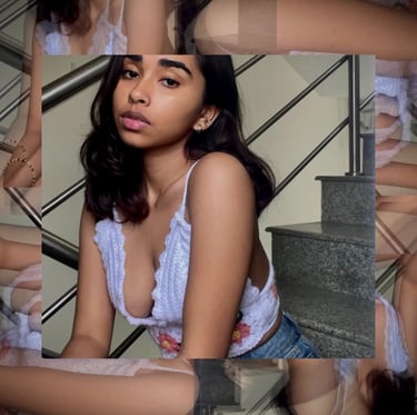 a woman in a white bra top and jeans shorts