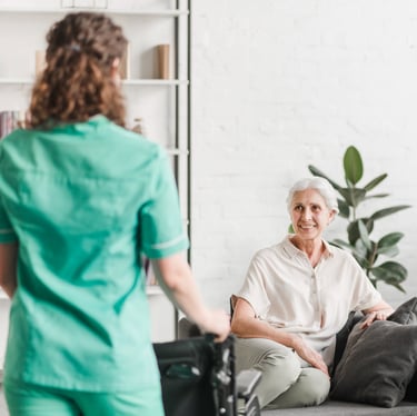 a caregiver and a senior woman in a living room