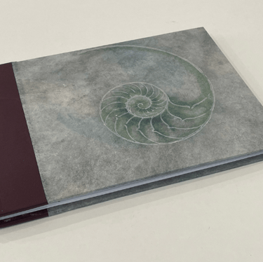 Journal with leather spine and shell design cover