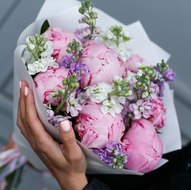 a girl holding a bouquet of flowers in the hands