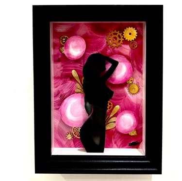 a woman in a black dress standing in front of a pink flower
