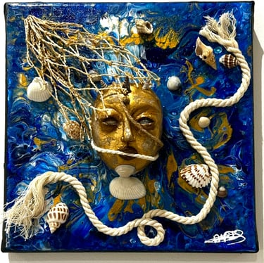 a blue and white tile with a face on it