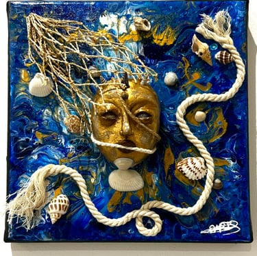 a blue and white tile with a face on it