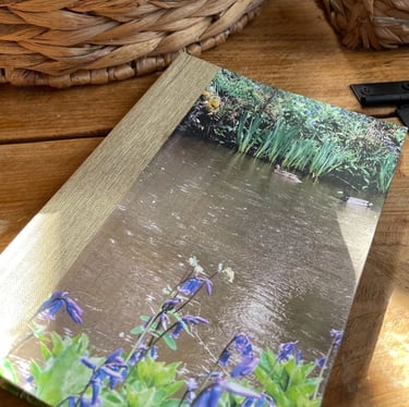 A unique one of a kind handbound notebook made using an original photo of ducks and bluebells