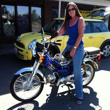 woman on moped with dog