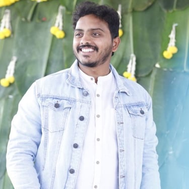 a man in a denim jacket and white shirt