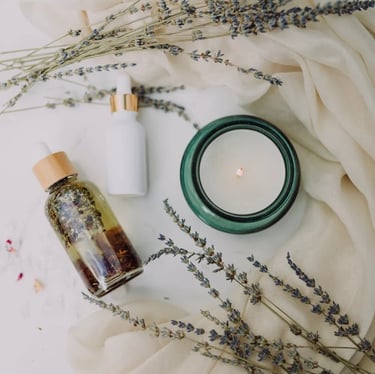  a candle on a table with face oil 