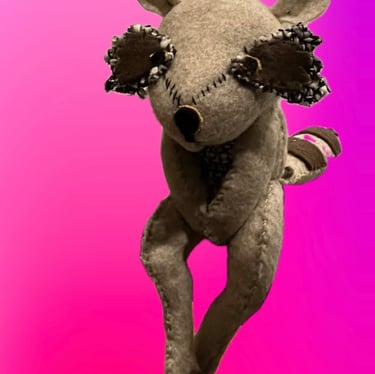 raccoon sculpture made of sewn felt patches