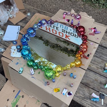 Round mirror made of rainbow disco balls