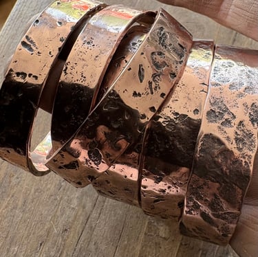 Copper cuffs textured with rocks and stones