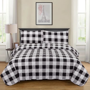 a bed with a black and white checkered checkered bedspread