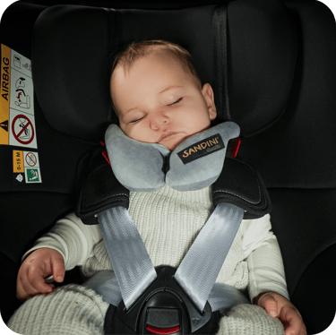 a baby in a car seat with a sleeping pillow sleepfix