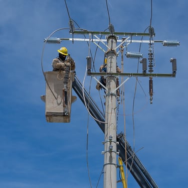 a man in a hard hat working on a pole