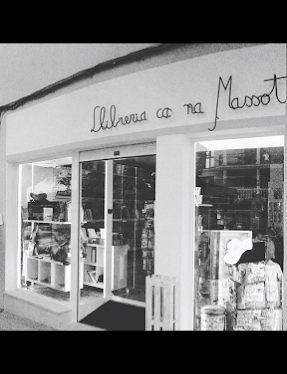 a store front of a store with a woman in a dress