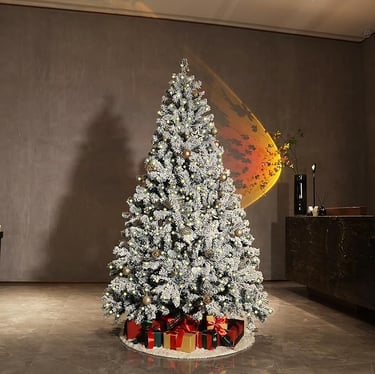 4ft Pre-Lit Snow Flocked Christmas Tree with 1a christmas tree with presents and presents on a table