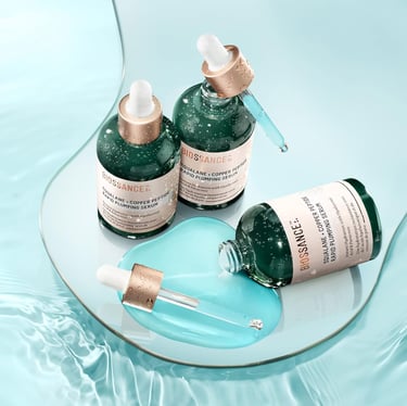 a group of three bottles of skin care products