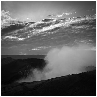 NIcaragua: a black and white photo of a person standing on a hill
