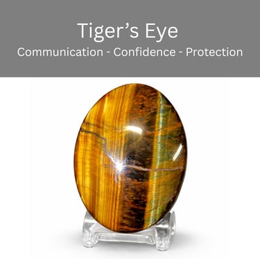 Polished oval Tiger's Eye crystal on a stand for confidence, protection, and communication.