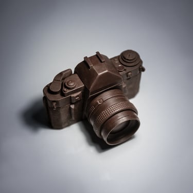 Photograph showing a top three-quarter view of a handcrafted chocolate camera. Click to view Chocola