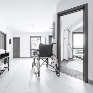 a wheelchair positioned outside a bathroom of a supported living home 