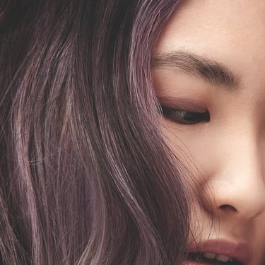 a woman with long hair and purple hair