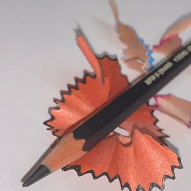 a pencil and pencil sharpener on a piece of paper
