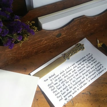 A handwritten letter with a brass letter opener