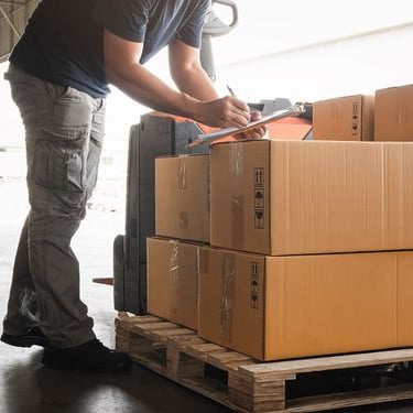 a man is standing in front of a stack of boxes
