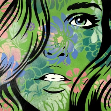 Artwork of a womans face in green spray paint