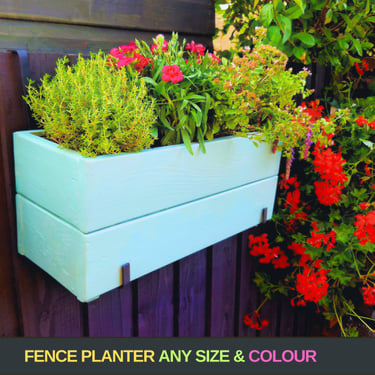 handmade planter box painted in blue with flowers and herbs