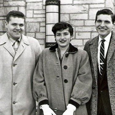 two men and a woman standing next to each other