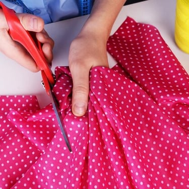 pink fabric being cut to create a keepsake