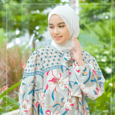 a woman in a floral dress with a hijab