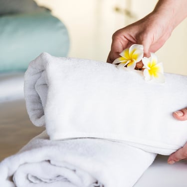 a person holding a towel over a towel