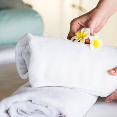 a person holding a towel over a towel