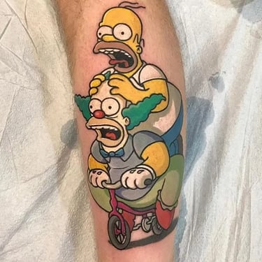 a cartoonish simpsons tattoos on a man's leg