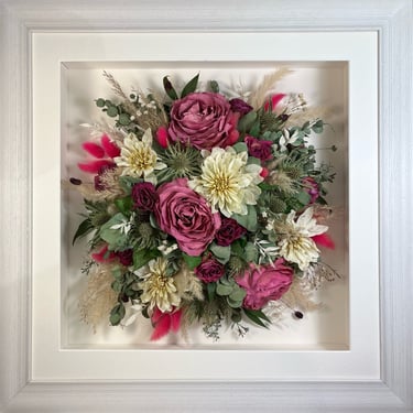 a Birdseye view preserved wedding bouquet in a frame