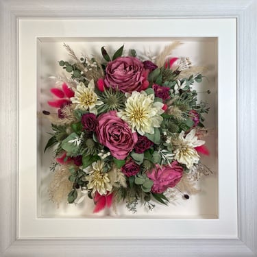 a Birdseye view Style bouquet of flowers in a rustic white frame