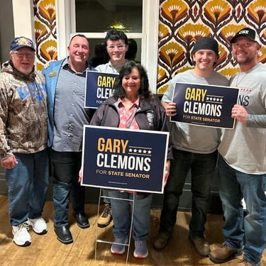 a group of people holding signs that read,'gary clemons, and