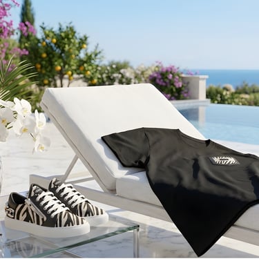 Stylish black t-shirt and zebra print sneakers by a luxury poolside resort terrace with ocean views.