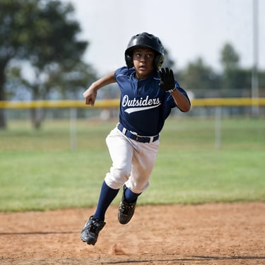 A youth baseball player sprints around the bases.