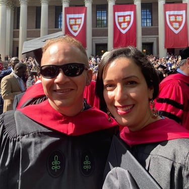 a man and woman in graduation gowns and caps