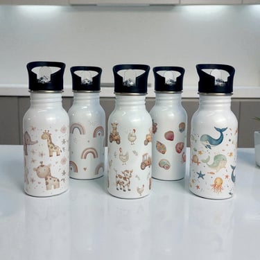 a variety of water bottles with a bowl of fruit