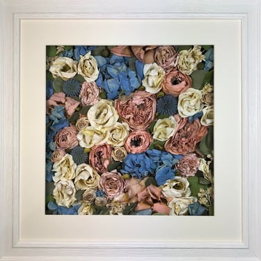 a pink and blue flower wall style preserved wedding bouquet in a frame