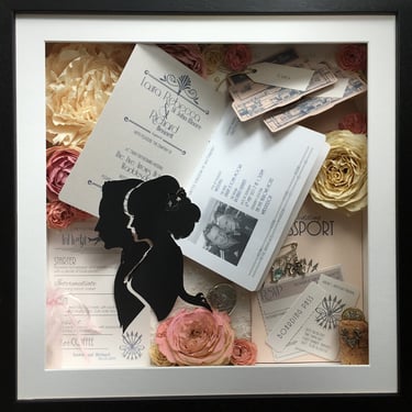 memory box full of preserved wedding flowers and passport themed invitation