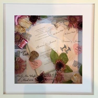 a memory box with keepsakes and a preserved wedding bouquet in a frame