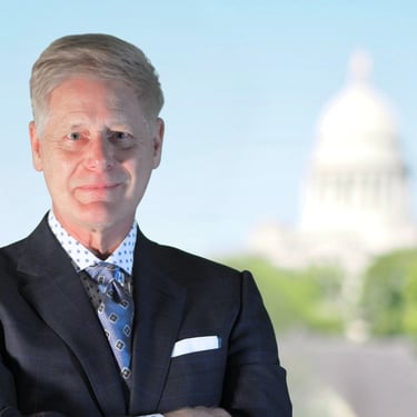 Arkansas Wrongful Death Lawyer Gene Ludwig poses in front of State Capital Building