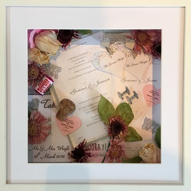 a Memory Box frame featuring wedding keepsakes and flowers