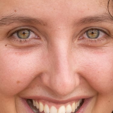 a woman with curly hair and earrings on her head