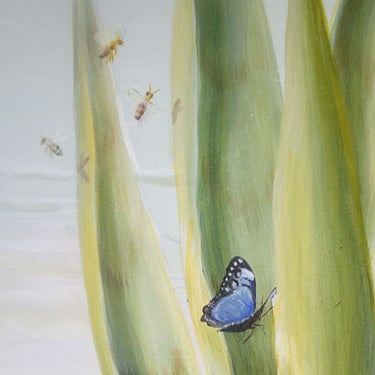 Detail of a mural showing an agave plant with a blue butterfly and bees.